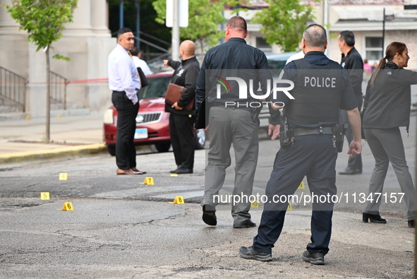 Shell casings are being recovered at the crime scene. A 19-year-old male victim is being shot and killed in Chicago, Illinois, United States...