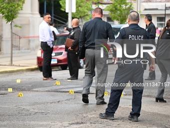 Shell casings are being recovered at the crime scene. A 19-year-old male victim is being shot and killed in Chicago, Illinois, United States...