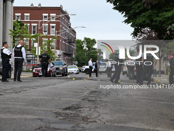 Shell casings are being recovered at the crime scene. A 19-year-old male victim is being shot and killed in Chicago, Illinois, United States...