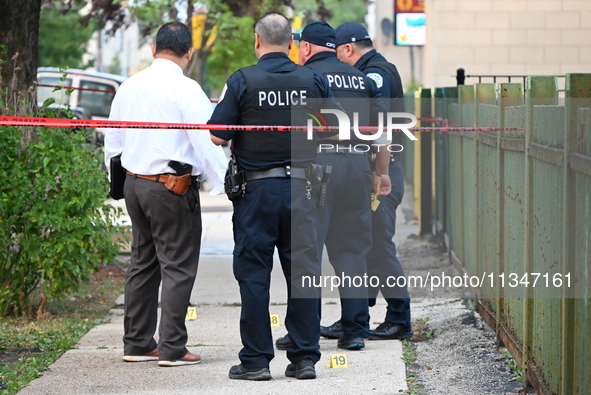 Police officers are investigating the crime scene. Shell casings are being recovered at the crime scene. A 19-year-old male victim is being...