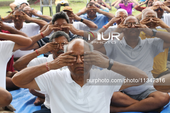 People are performing yoga on International Day of Yoga at the Brigade Parade Ground in Kolkata, India, on June 21, 2024. 