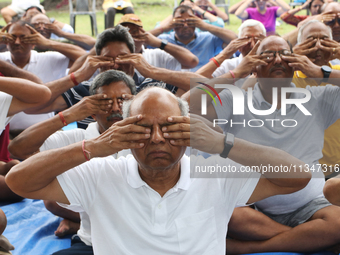 People are performing yoga on International Day of Yoga at the Brigade Parade Ground in Kolkata, India, on June 21, 2024. (