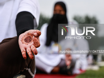 People are taking part in the 10th International Yoga Day Celebrations in Baramulla, Jammu and Kashmir, India, on June 21, 2024. Indian Prim...