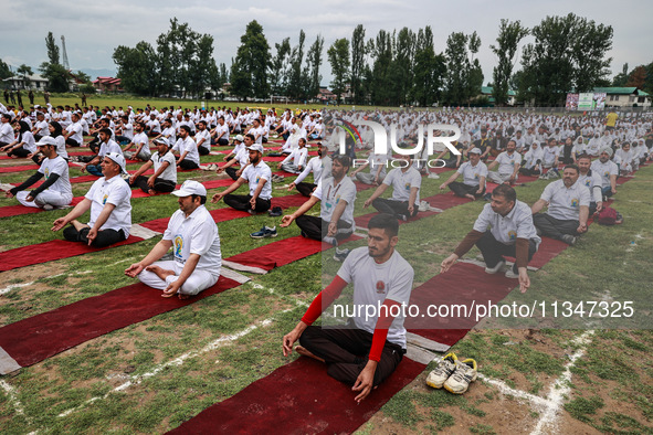 People are taking part in the 10th International Yoga Day Celebrations in Baramulla, Jammu and Kashmir, India, on June 21, 2024. Indian Prim...