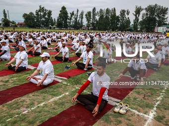 People are taking part in the 10th International Yoga Day Celebrations in Baramulla, Jammu and Kashmir, India, on June 21, 2024. Indian Prim...