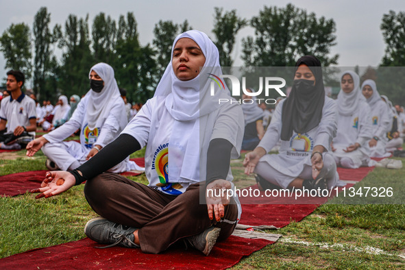 People are taking part in the 10th International Yoga Day Celebrations in Baramulla, Jammu and Kashmir, India, on June 21, 2024. Indian Prim...