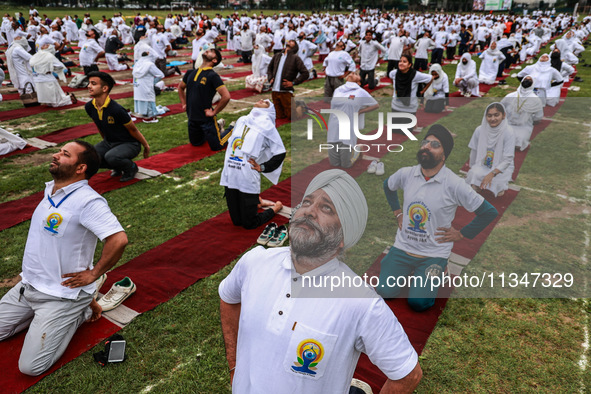 People are taking part in the 10th International Yoga Day Celebrations in Baramulla, Jammu and Kashmir, India, on June 21, 2024. Indian Prim...