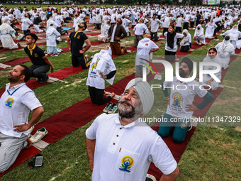 People are taking part in the 10th International Yoga Day Celebrations in Baramulla, Jammu and Kashmir, India, on June 21, 2024. Indian Prim...