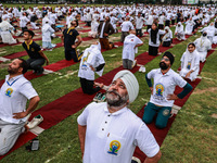 People are taking part in the 10th International Yoga Day Celebrations in Baramulla, Jammu and Kashmir, India, on June 21, 2024. Indian Prim...