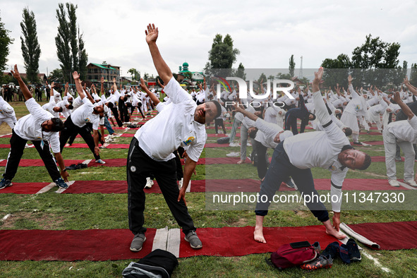 People are taking part in the 10th International Yoga Day Celebrations in Baramulla, Jammu and Kashmir, India, on June 21, 2024. Indian Prim...