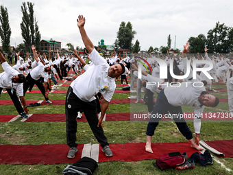 People are taking part in the 10th International Yoga Day Celebrations in Baramulla, Jammu and Kashmir, India, on June 21, 2024. Indian Prim...