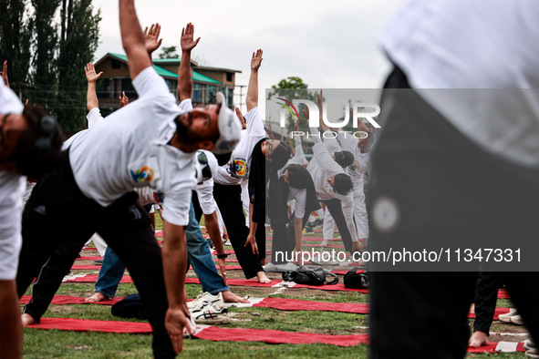 People are taking part in the 10th International Yoga Day Celebrations in Baramulla, Jammu and Kashmir, India, on June 21, 2024. Indian Prim...