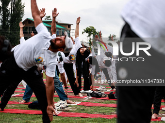 People are taking part in the 10th International Yoga Day Celebrations in Baramulla, Jammu and Kashmir, India, on June 21, 2024. Indian Prim...