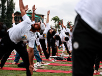 People are taking part in the 10th International Yoga Day Celebrations in Baramulla, Jammu and Kashmir, India, on June 21, 2024. Indian Prim...