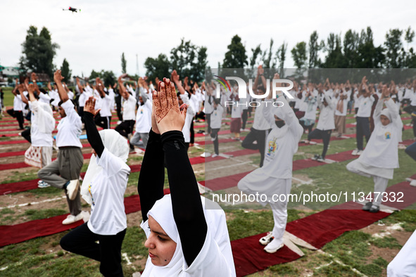 People are taking part in the 10th International Yoga Day Celebrations in Baramulla, Jammu and Kashmir, India, on June 21, 2024. Indian Prim...