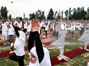 People are taking part in the 10th International Yoga Day Celebrations in Baramulla, Jammu and Kashmir, India, on June 21, 2024. Indian Prim...