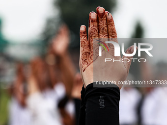 People are taking part in the 10th International Yoga Day Celebrations in Baramulla, Jammu and Kashmir, India, on June 21, 2024. Indian Prim...