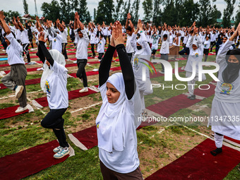 People are taking part in the 10th International Yoga Day Celebrations in Baramulla, Jammu and Kashmir, India, on June 21, 2024. Indian Prim...