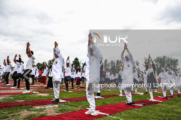 People are taking part in the 10th International Yoga Day Celebrations in Baramulla, Jammu and Kashmir, India, on June 21, 2024. Indian Prim...