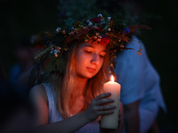 A girl celebrates the summer solstice during the 'Kupala Night' by the Krakus Mound in Krakow, Poland on June 20th, 2024. The Kupała Night i...