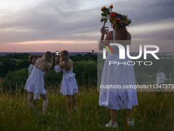 Participants celebrating the summer solstice gathered for the 'Kupala Night' by the Krakus Mound in Krakow, Poland on June 20th, 2024. The K...