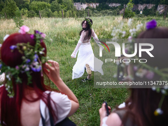 Participants celebrating the summer solstice gathered for the 'Kupala Night' by the Krakus Mound in Krakow, Poland on June 20th, 2024. The K...