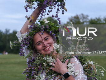 A girl celebrates the summer solstice during the 'Kupala Night' by the Krakus Mound in Krakow, Poland on June 20th, 2024. The Kupała Night i...