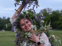 A girl celebrates the summer solstice during the 'Kupala Night' by the Krakus Mound in Krakow, Poland on June 20th, 2024. The Kupała Night i...