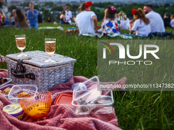 Food and drinks are seen on a blanket during celebration of the summer solstice and the 'Kupala Night' by the Krakus Mound in Krakow, Poland...