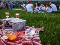 Food and drinks are seen on a blanket during celebration of the summer solstice and the 'Kupala Night' by the Krakus Mound in Krakow, Poland...