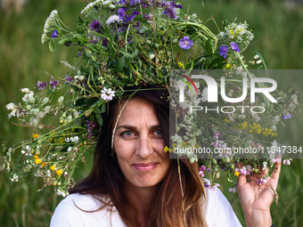 A girl celebrates the summer solstice during the 'Kupala Night' by the Krakus Mound in Krakow, Poland on June 20th, 2024. The Kupała Night i...