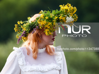 A girl celebrates the summer solstice during the 'Kupala Night' by the Krakus Mound in Krakow, Poland on June 20th, 2024. The Kupała Night i...