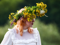 A girl celebrates the summer solstice during the 'Kupala Night' by the Krakus Mound in Krakow, Poland on June 20th, 2024. The Kupała Night i...