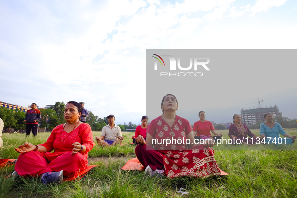 People are performing yoga on the occasion of International Yoga Day. 