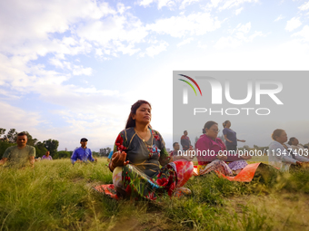 People are performing yoga on the occasion of International Yoga Day. (