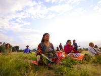 People are performing yoga on the occasion of International Yoga Day. (