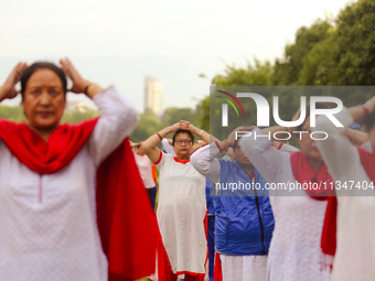 People are performing yoga on the occasion of International Yoga Day. (