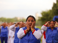 People are performing yoga on the occasion of International Yoga Day. (