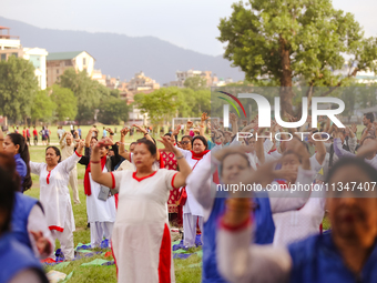 People are performing yoga on the occasion of International Yoga Day. (