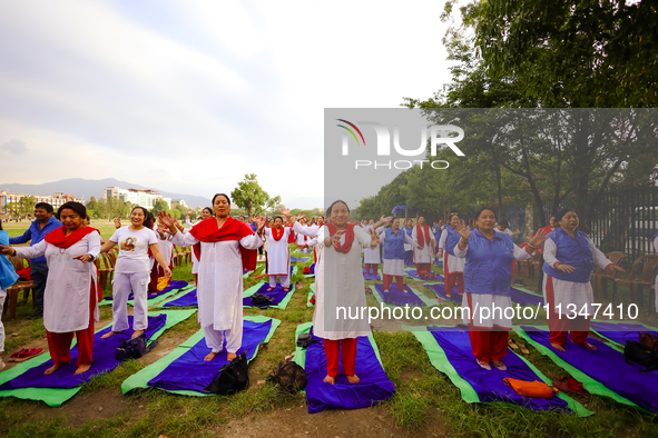 People are performing yoga on the occasion of International Yoga Day. 