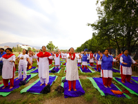 People are performing yoga on the occasion of International Yoga Day. (