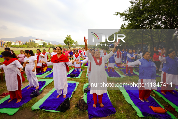 People are performing yoga on the occasion of International Yoga Day. 