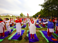 People are performing yoga on the occasion of International Yoga Day. (