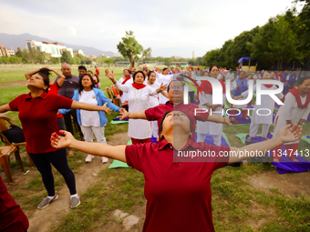 People are performing yoga on the occasion of International Yoga Day. (