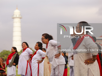 People are performing yoga on the occasion of International Yoga Day. (