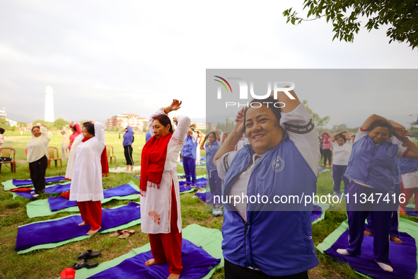 People are performing yoga on the occasion of International Yoga Day. 