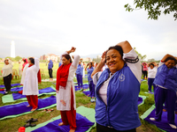 People are performing yoga on the occasion of International Yoga Day. (