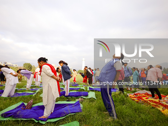 People are performing yoga on the occasion of International Yoga Day. (