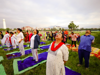 People are performing yoga on the occasion of International Yoga Day. (