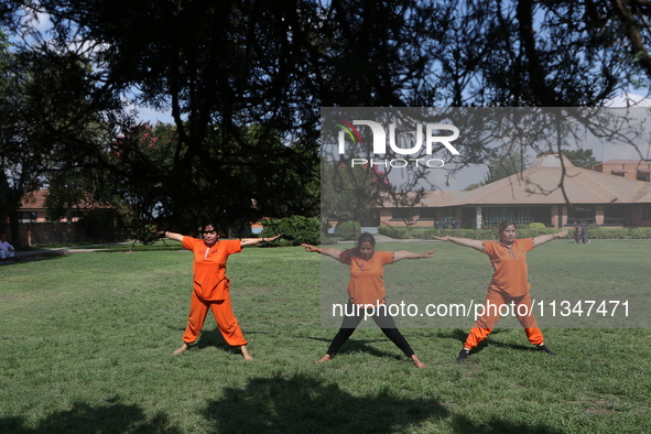 Nepalese people are practicing Yoga at an open ground in Bhaktapur, Nepal, on June 21, 2024, on the occasion of International Yoga Day. 